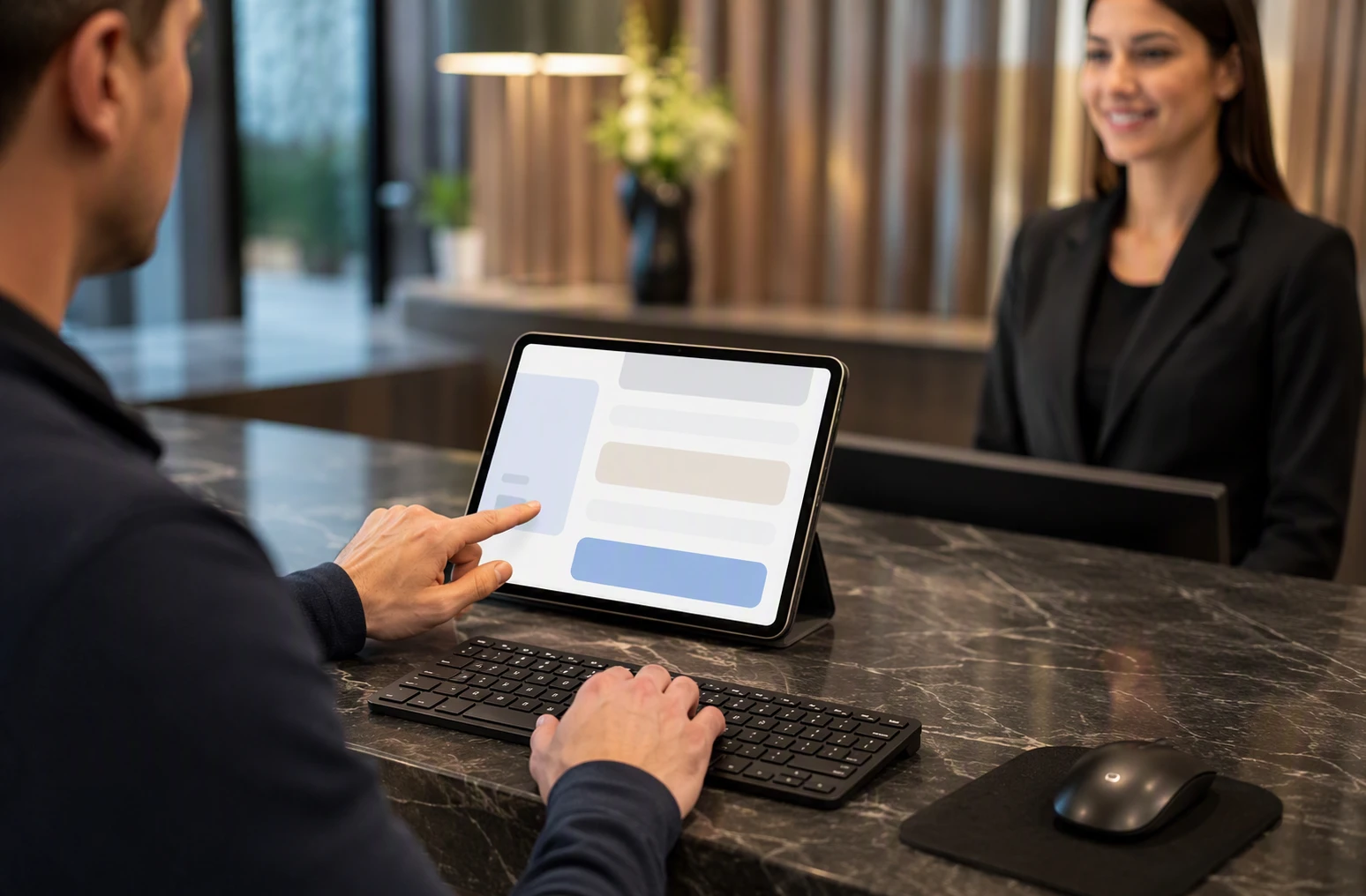 Customer using external keyboard at reception desk on tablet
