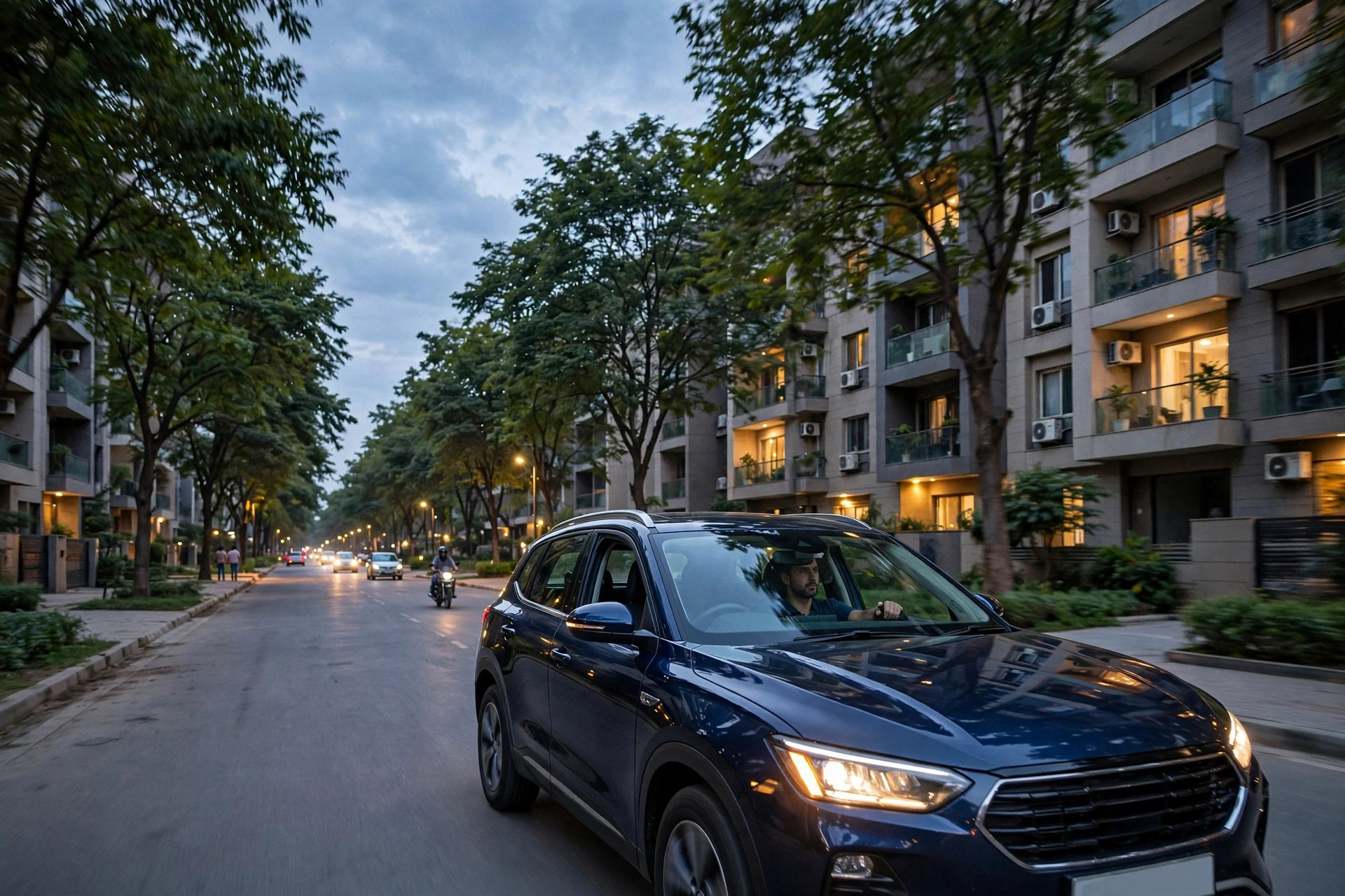 Buyer driving through tree-lined Gurugram sector at dusk